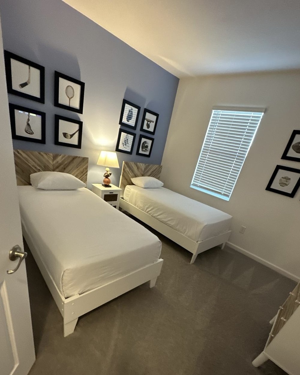 After: a twin bedroom, beds made and the room tidy